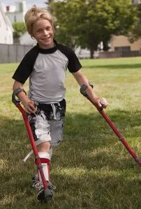 Boy walking on crutches with Multiple Dystrophy