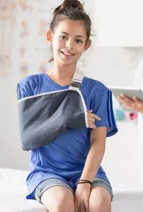 Girl with sling on her arm seeing Orthopedics doctor